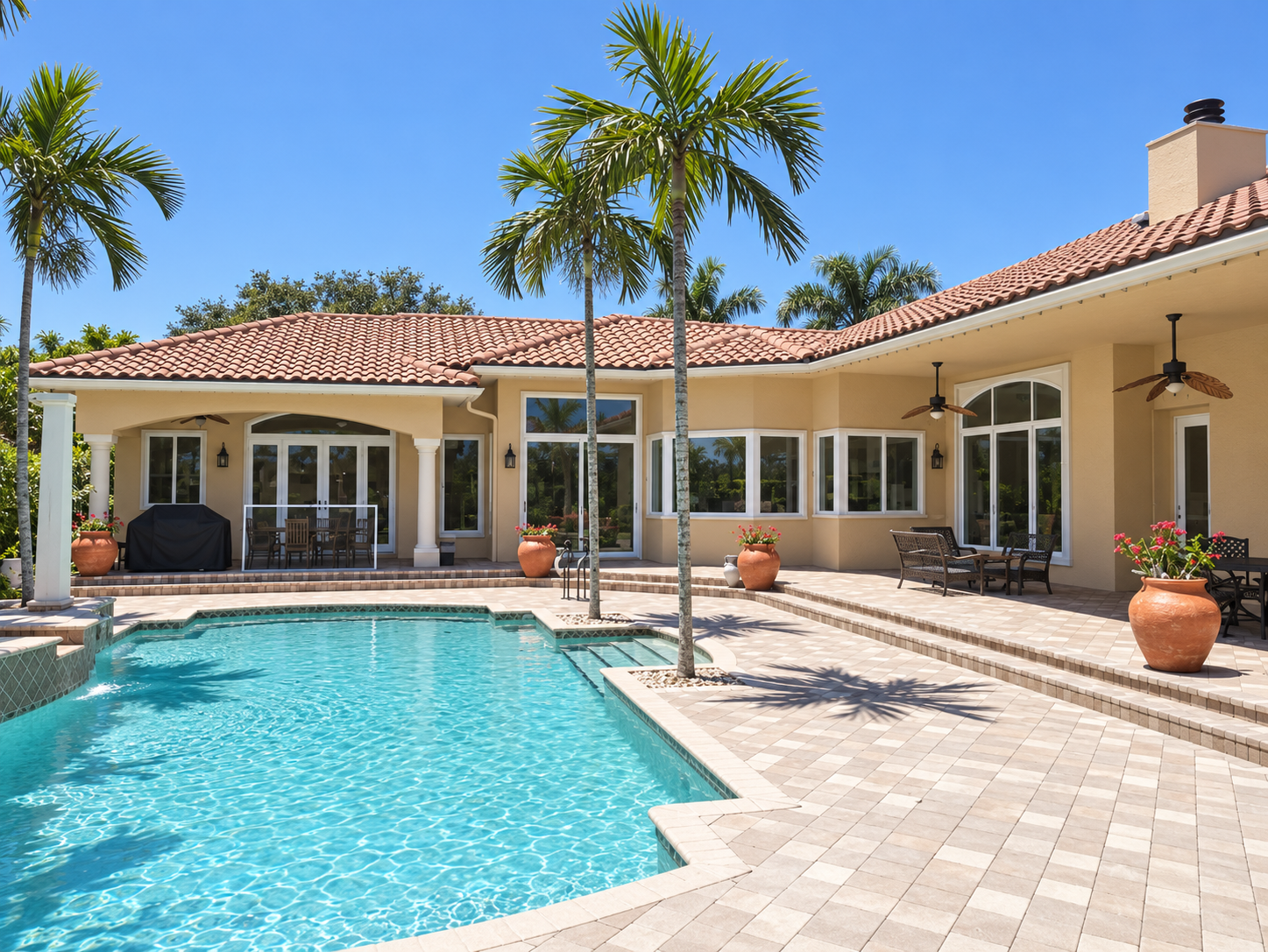 Finished rear pool facade with clean white window and sliding door frames, freshly painted exterior and uncovered pool