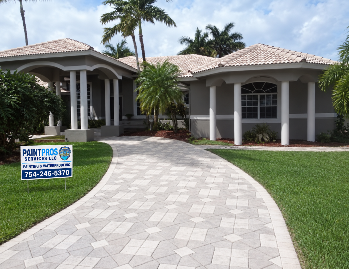 Southwest Ranches house after exterior painting, with finished gray walls, white trim, green lawn and matching PaintPros yard sign
