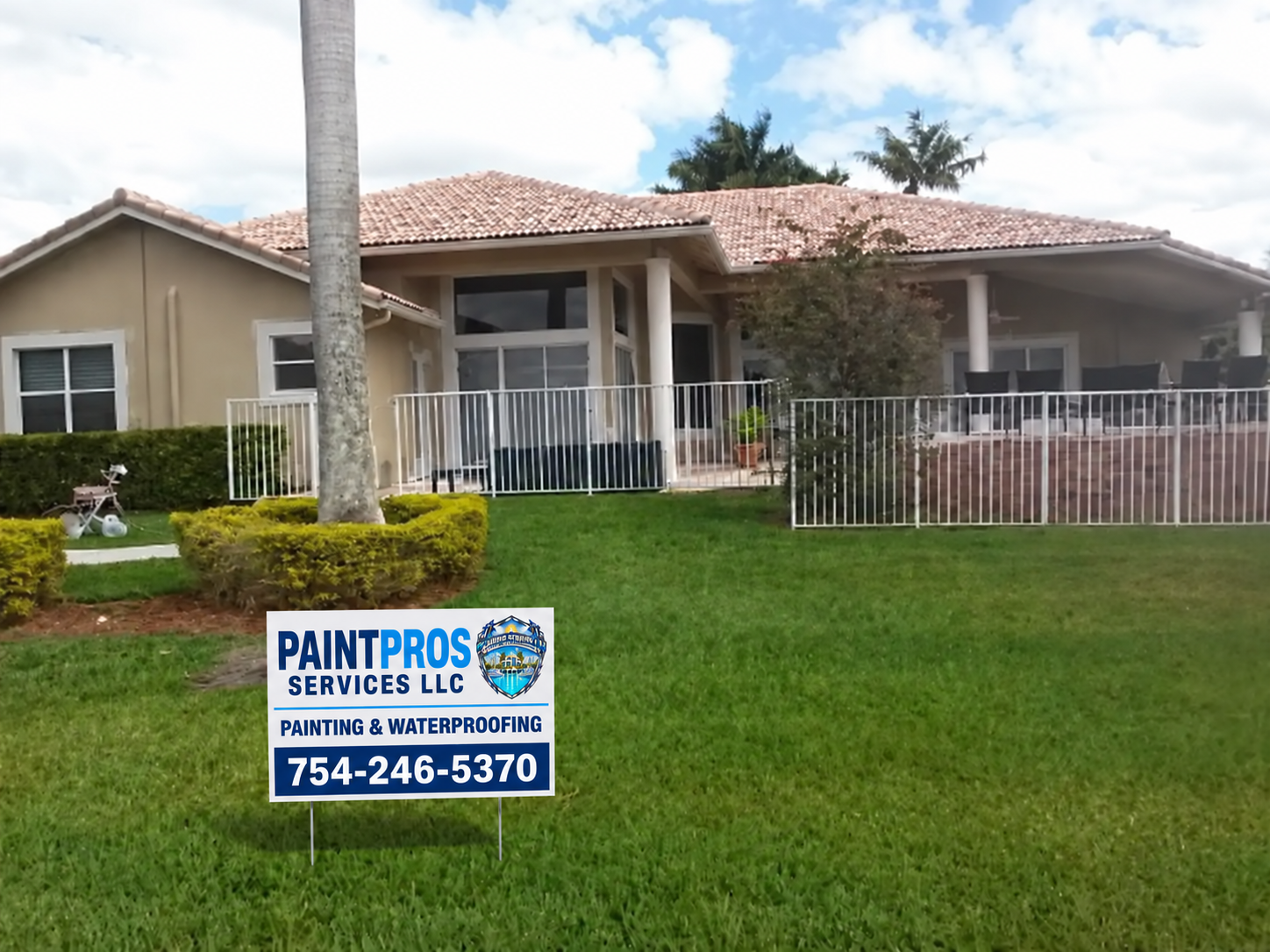 Same rear patio house after exterior painting with the approved PaintPros yard sign