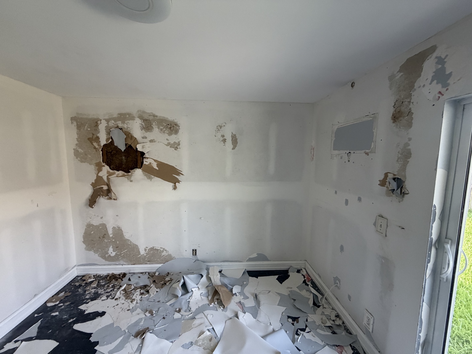 The same Plantation room with extensive wall damage before PaintPros restoration