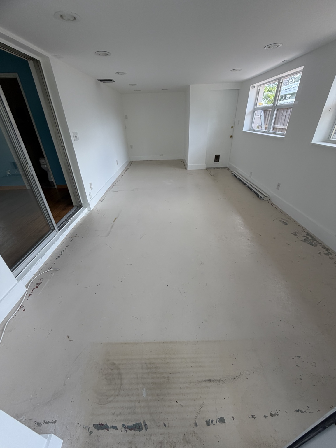 The same Oakland Park patio floor worn and uncoated before PaintPros preparation